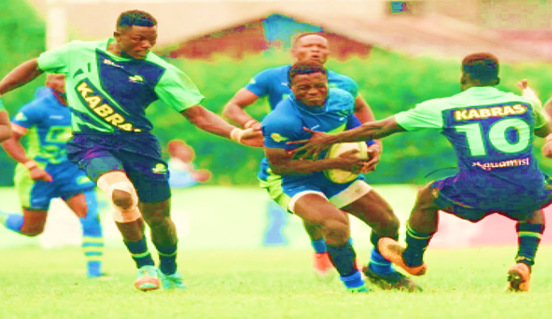 Festus Shiasi with ball of KCB RFC is tackled by Kabras Sugar RFC